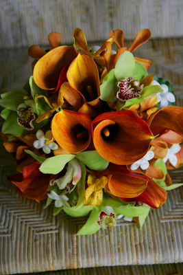orange min calla lilies with green orchids for bride