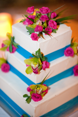 wedding cake with aqau ribbon and pink roses