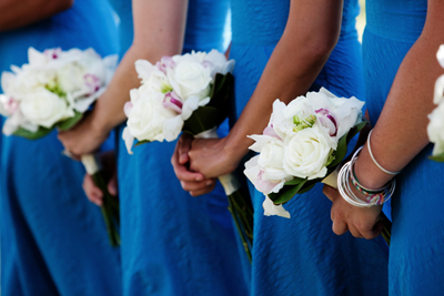 bridemaids with blue dresses and white flowers