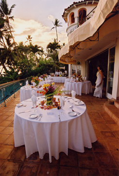 tables set with bright tropical flowers for a wedding