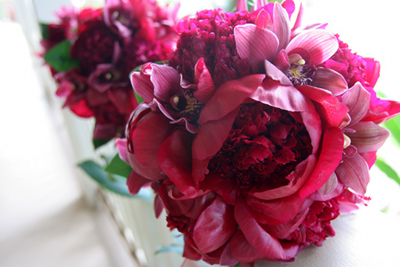 red peonies in bride's bouquet